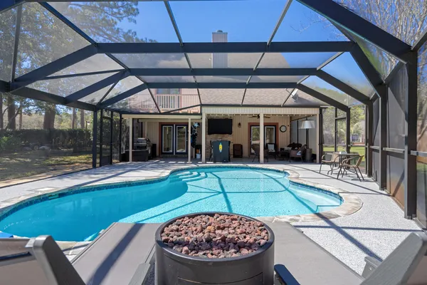an aerial view of house with yard swimming pool and outdoor seating