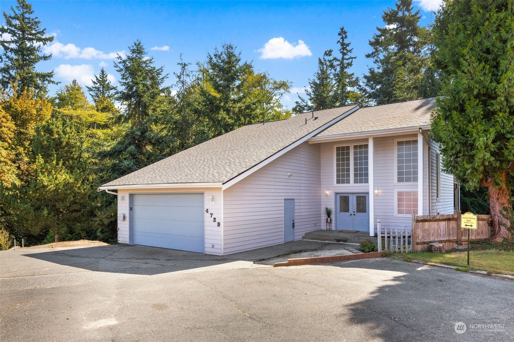 a view of a house with a yard and garage
