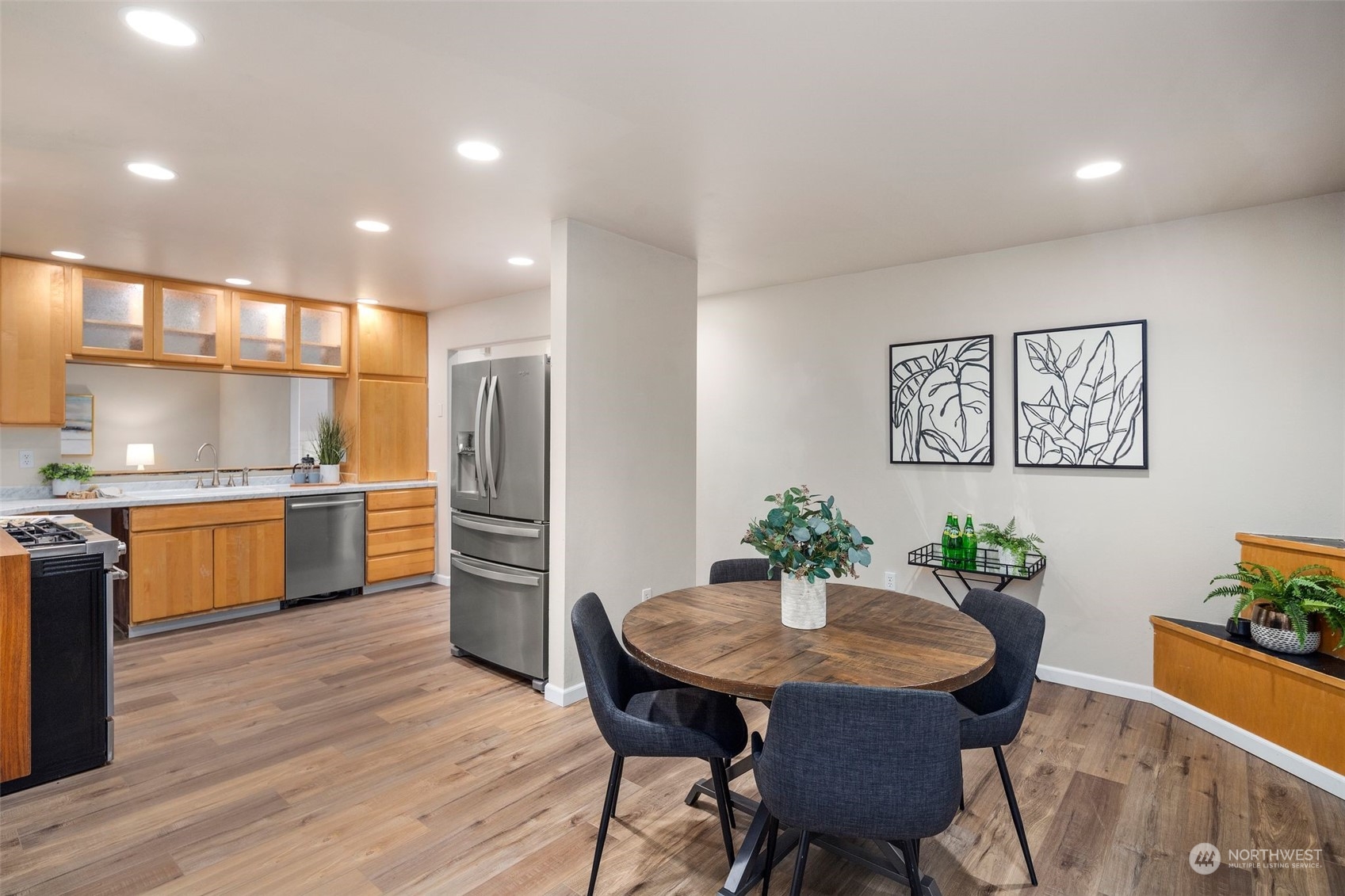 4729 Seahurst Avenue Everett, WA 98203 - Photo 13 of 40 a kitchen with stainless steel appliances kitchen island granite countertop a kitchen island a stove a dining table and chairs