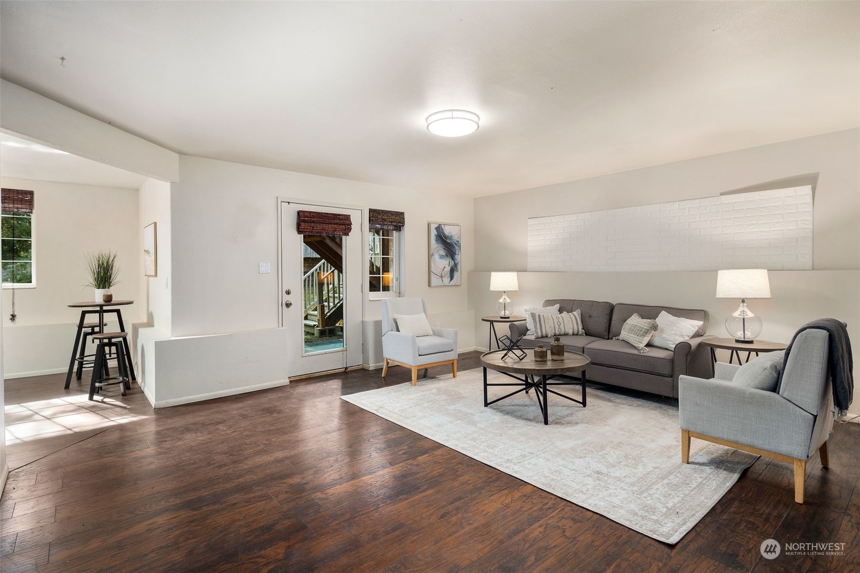 4729 Seahurst Avenue Everett, WA 98203 - Photo 16 of 40 a living room with furniture a wooden floor and a lamp