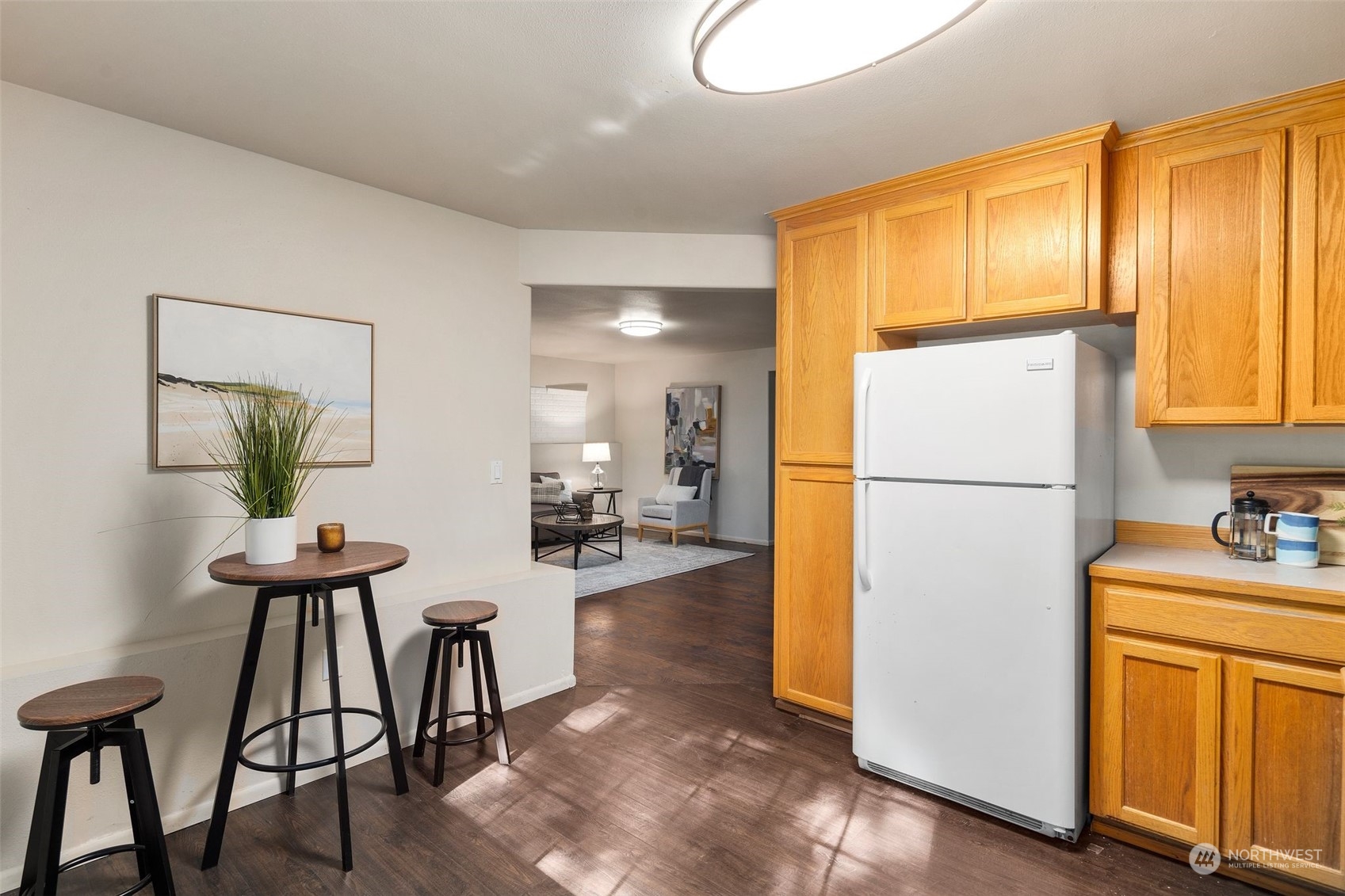 4729 Seahurst Avenue Everett, WA 98203 - Photo 21 of 40 a kitchen with refrigerator a table and chairs
