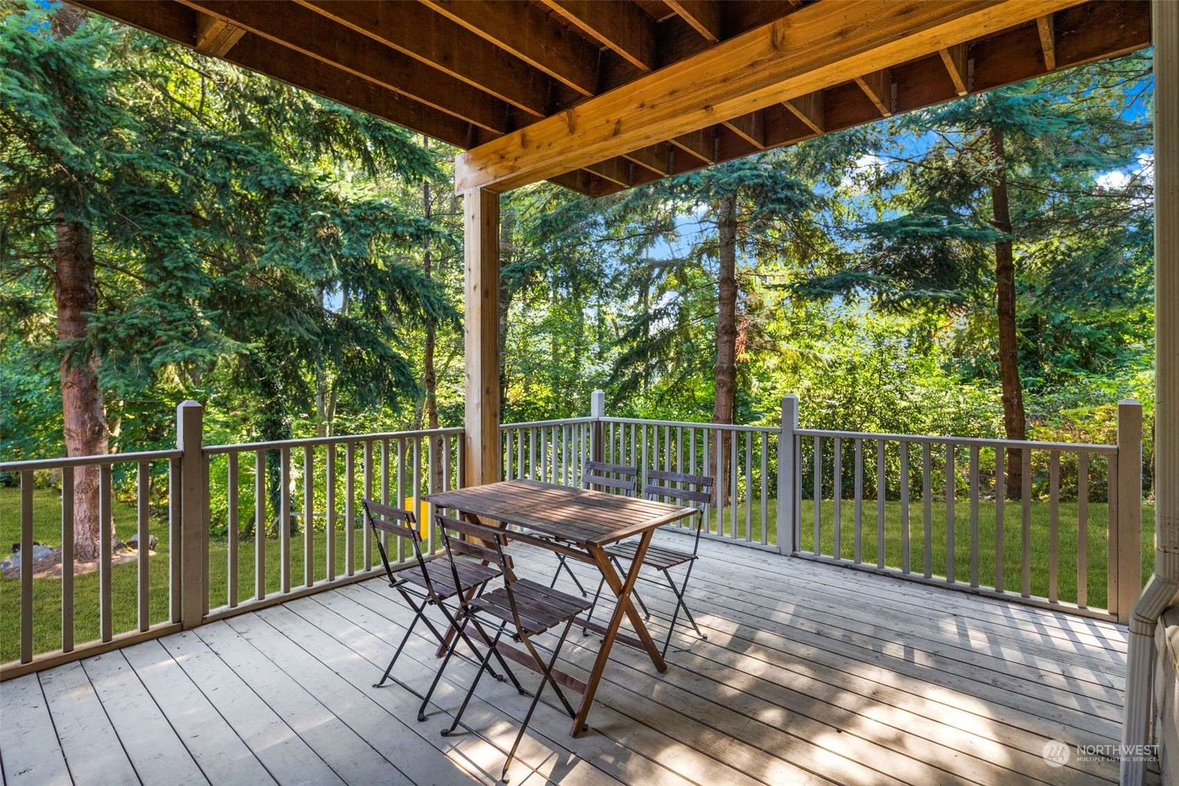 4729 Seahurst Avenue Everett, WA 98203 - Photo 25 of 40 a patio with water view fountain with wooden floor and fence