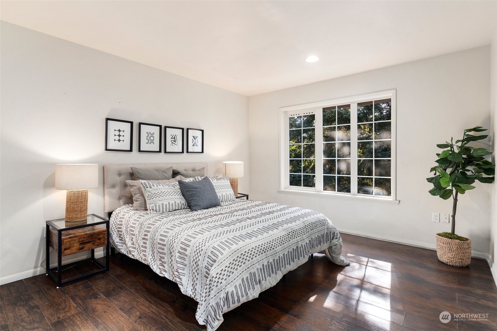 4729 Seahurst Avenue Everett, WA 98203 - Photo 34 of 40 a bedroom with a large bed and a potted plant