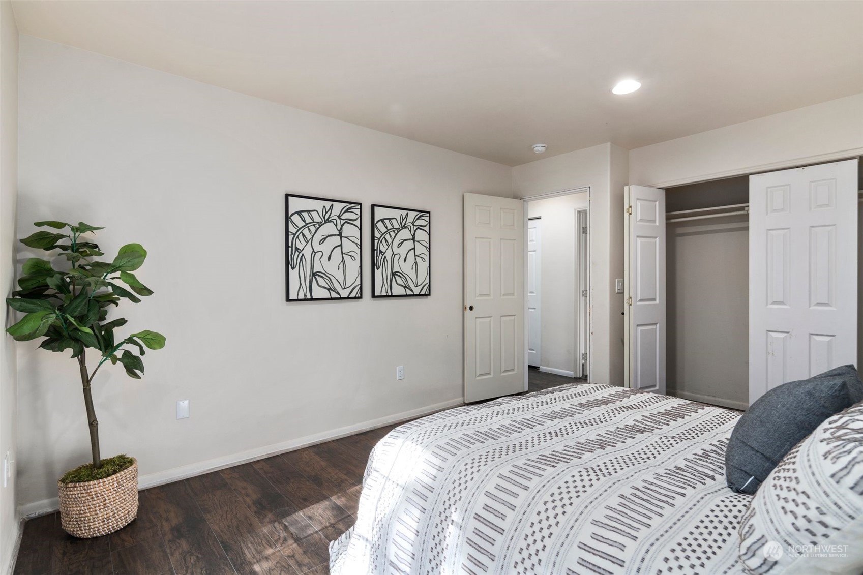 4729 Seahurst Avenue Everett, WA 98203 - Photo 35 of 40 a bedroom with a large bed and a potted plant