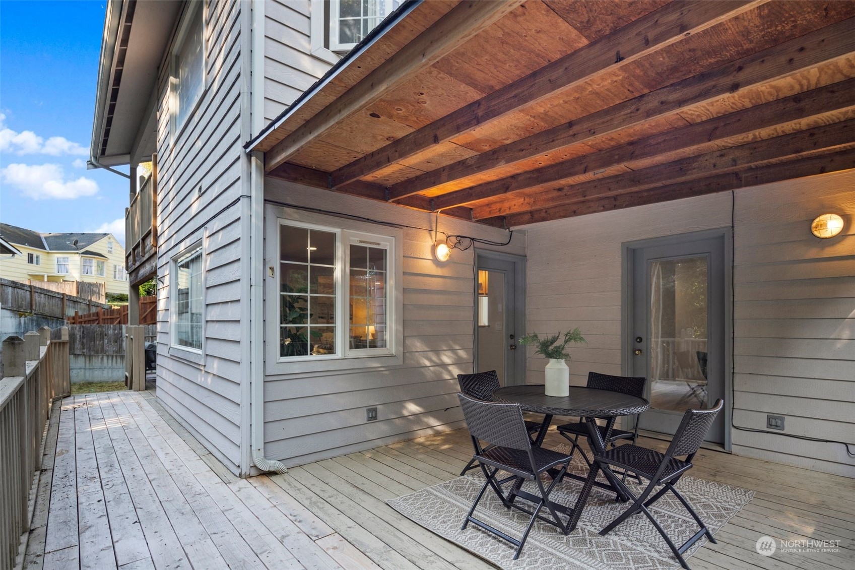4729 Seahurst Avenue Everett, WA 98203 - Photo 8 of 40 a view of a deck with table and chairs with wooden floor and fence