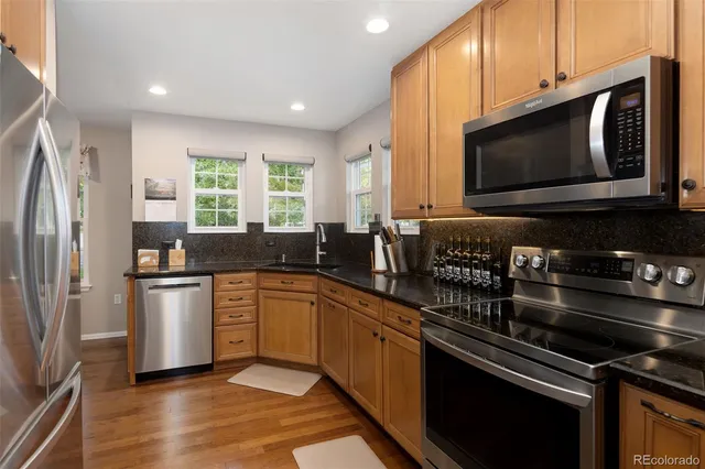 a kitchen with a sink stove and microwave