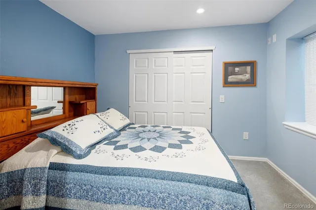 a view of a bedroom with furniture and window