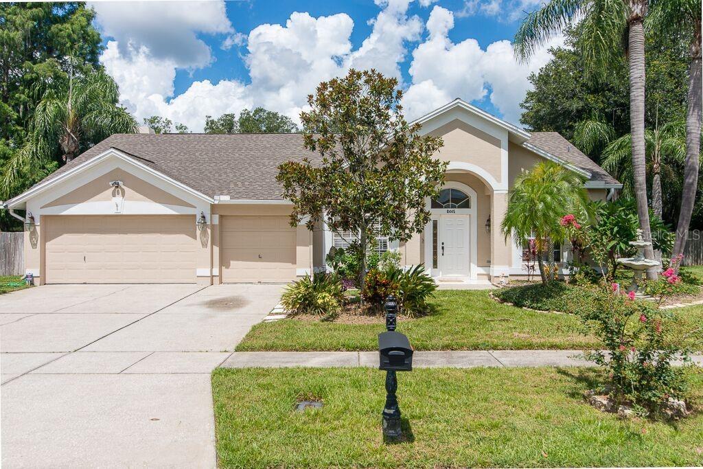 8445 Ridgebrook Circle Odessa, FL 33556 - Photo 1 of 1 a front view of a house with garden