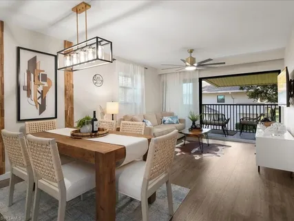 a dining room with wooden floor a chandelier a wooden table and chairs