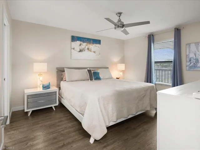 a bed room with a bed and a ceiling fan