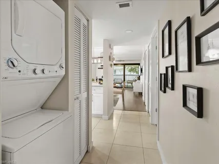 a view of a hallway with a washer and dryer