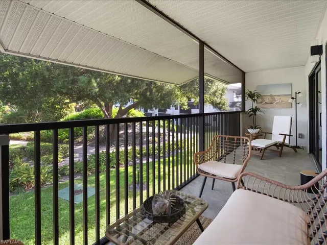 a view of a porch with furniture and wooden floor