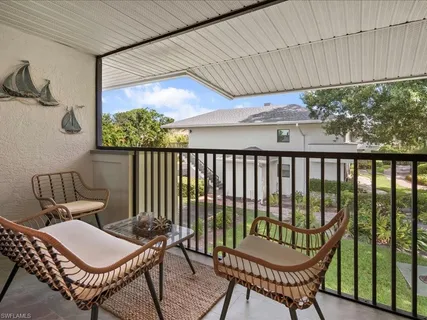 a view of a balcony with chairs