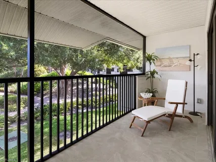 a view of a porch with furniture and a yard