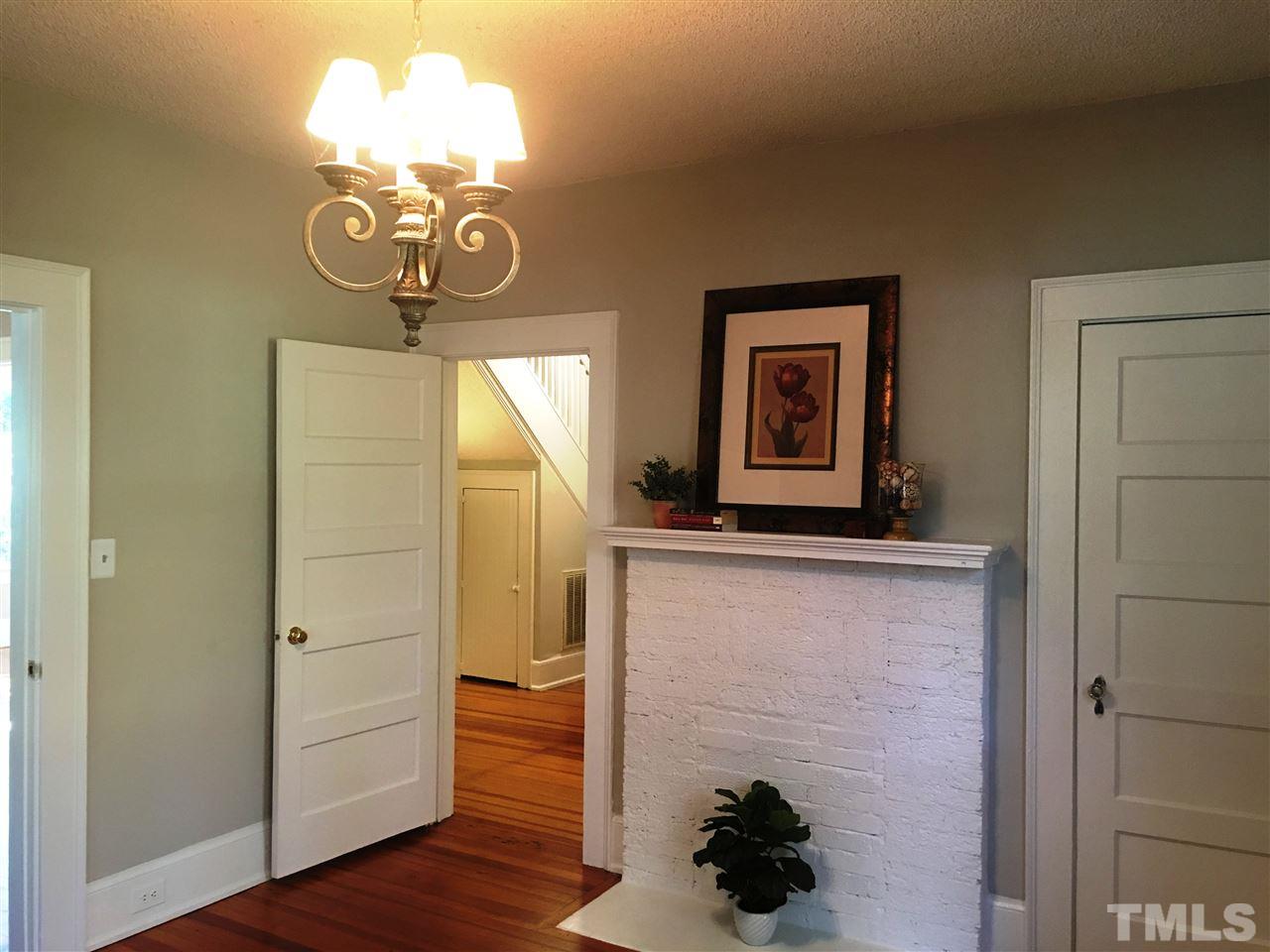 2515 University Station Road Durham, NC 27705 - Photo 14 of 29 1st floor bedroom with decorative fireplace and pretty heart pine floors and vintage glass door knobs...