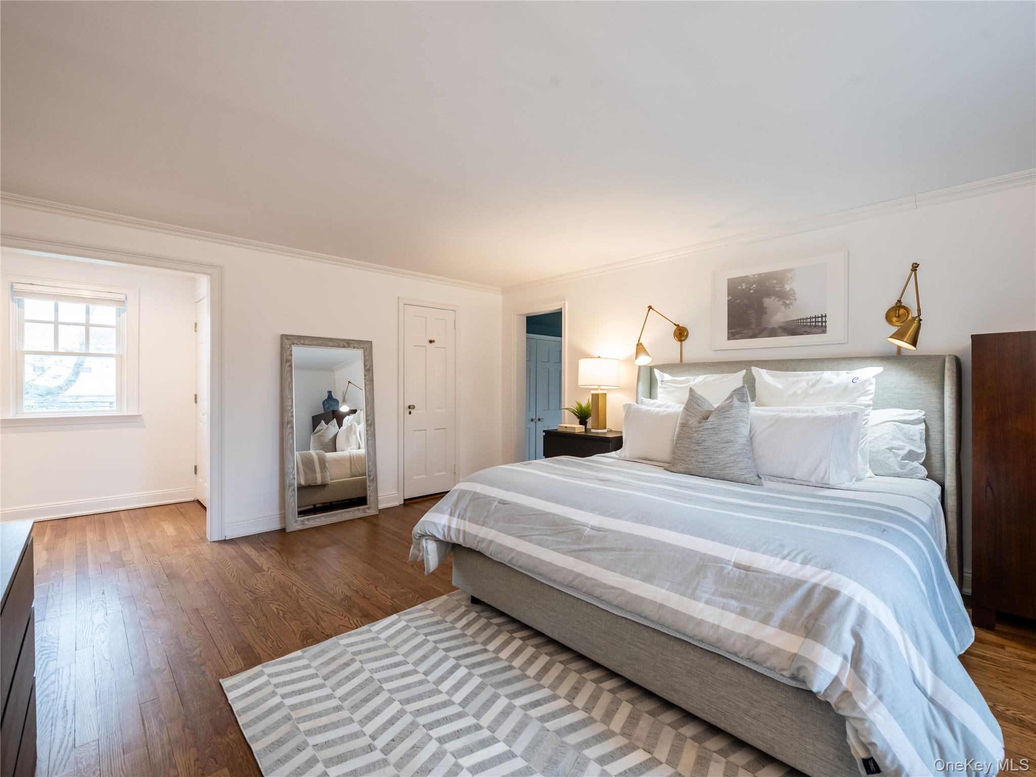 126 Northwoods Road Manhasset, NY 11030 - Photo 17 of 26 a bedroom with a bed and wooden floor