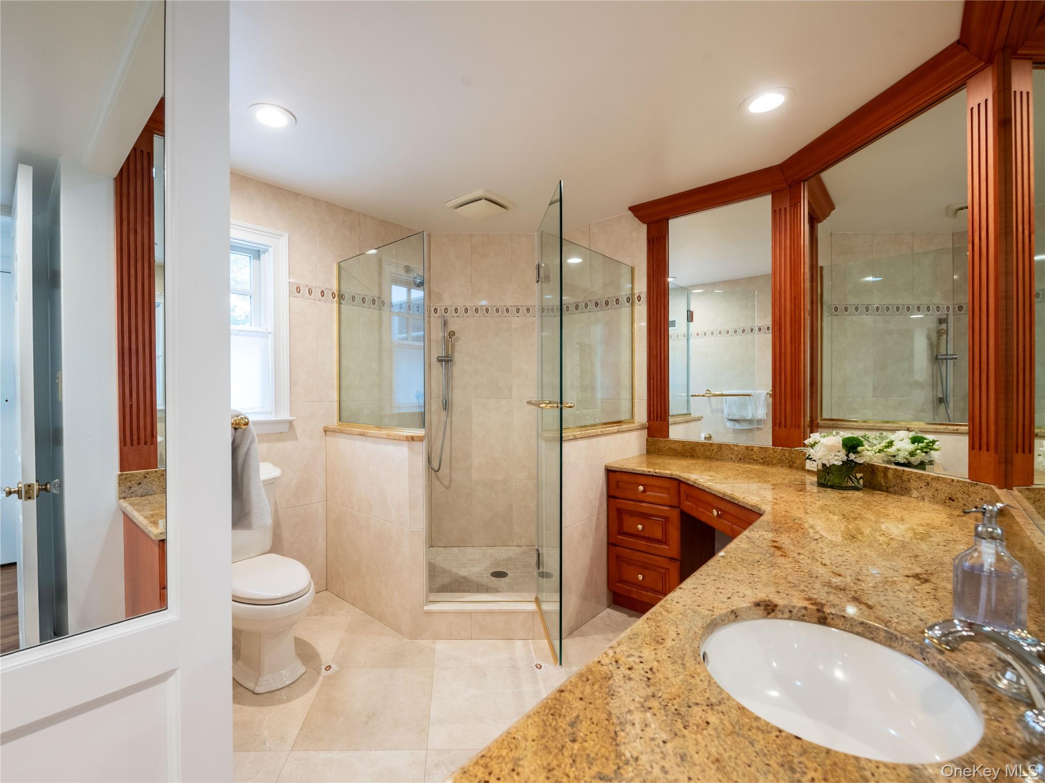 126 Northwoods Road Manhasset, NY 11030 - Photo 21 of 26 a bathroom with a granite countertop sink and a mirror
