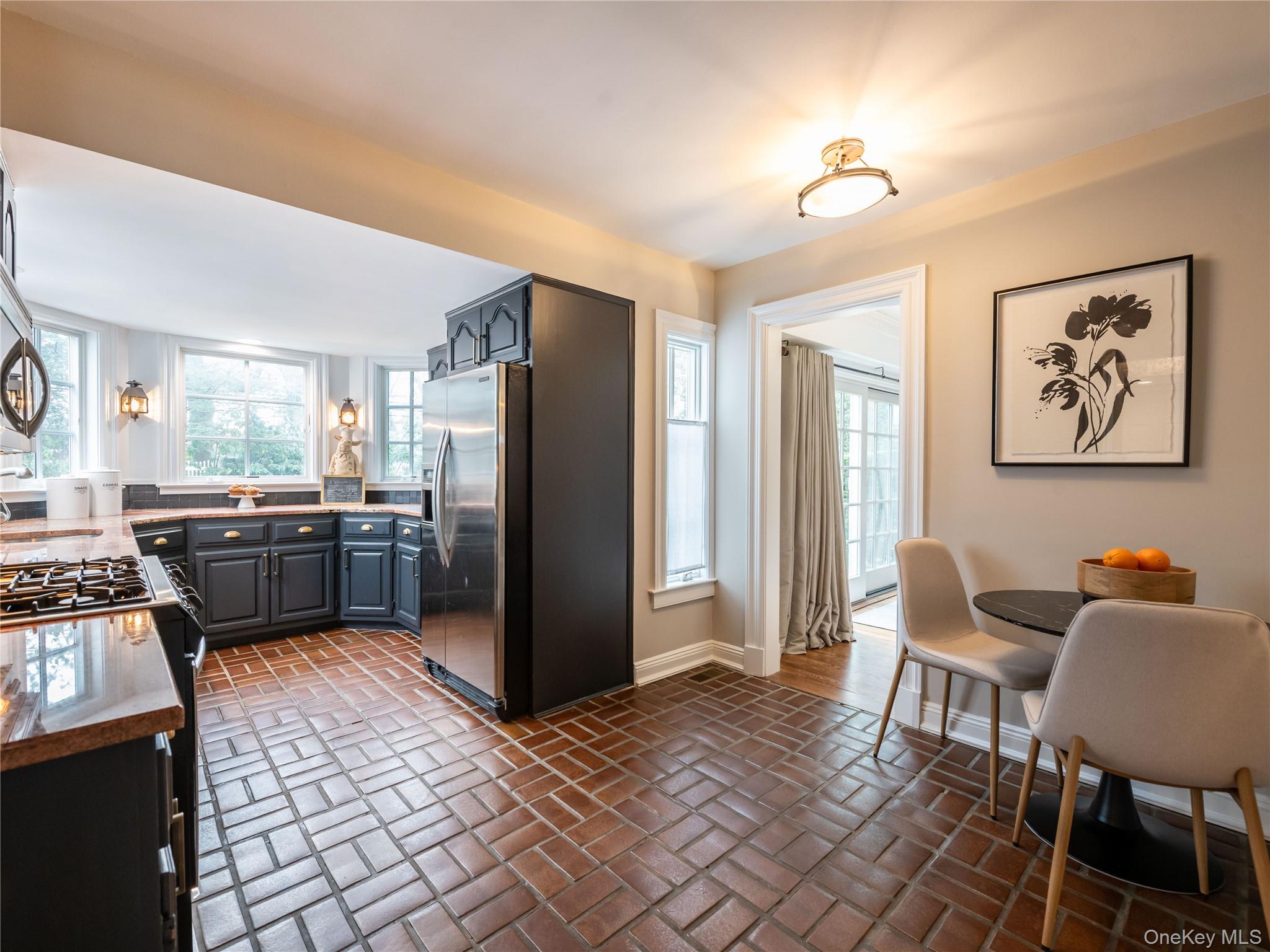 126 Northwoods Road Manhasset, NY 11030 - Photo 9 of 26 a kitchen with a refrigerator and furniture