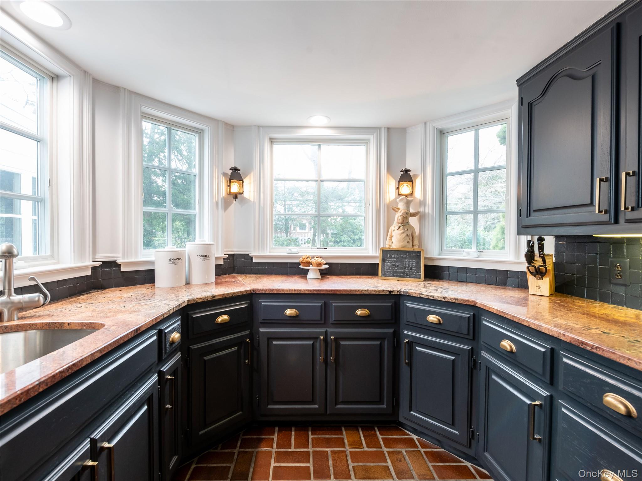 126 Northwoods Road Manhasset, NY 11030 - Photo 10 of 26 a kitchen with a sink stove and cabinets