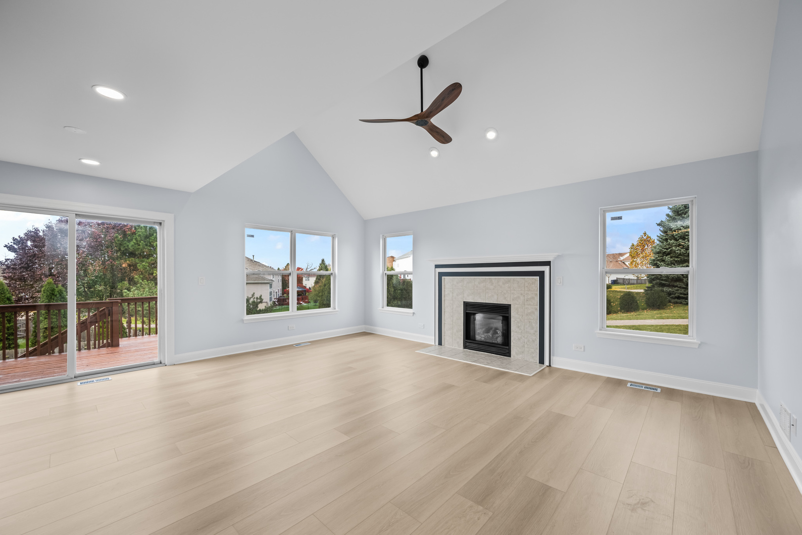 400 Diamond Back Way Algonquin, IL 60102 - Photo 9 of 23 an empty room with windows fireplace and wooden floor