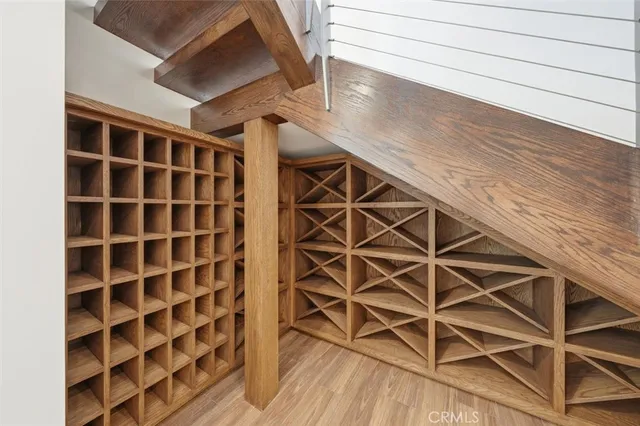 a bedroom with a large bed and a wooden floor