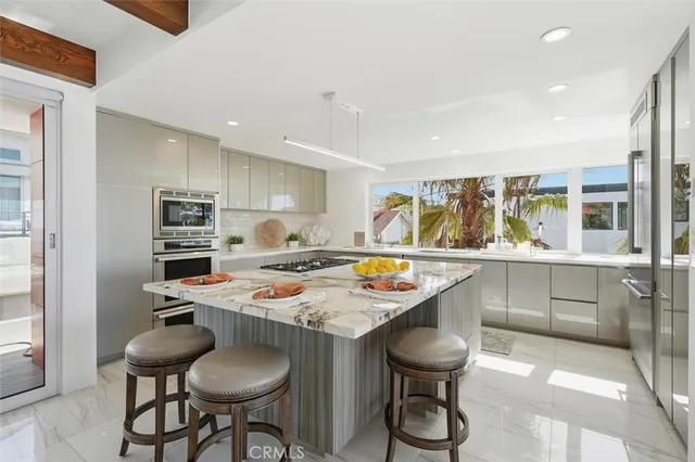 a kitchen with stainless steel appliances granite countertop a stove and a refrigerator