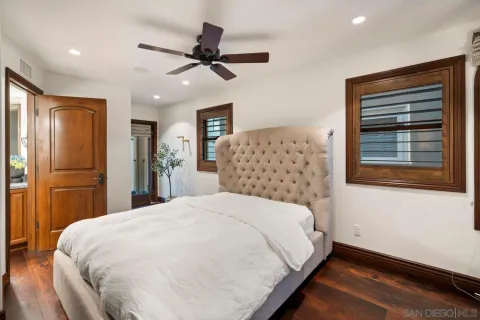 a large bed sitting in a bedroom next to a window