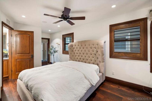 a large bed sitting in a bedroom next to a window