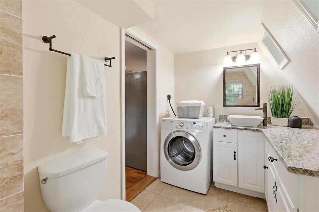 716 Lakeland Road Lake Dallas, TX 75065 - Photo 14 of 31 a utility room with cabinets washer and dryer
