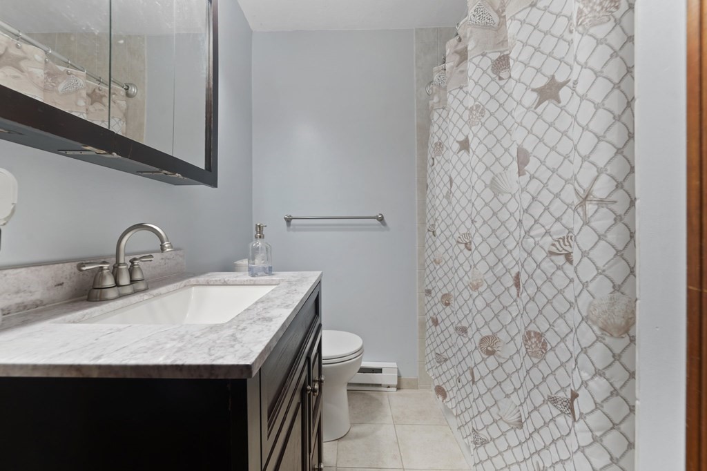 100 Barry Road Worcester, MA 01609 - Photo 20 of 37 a bathroom with a granite countertop sink and a toilet