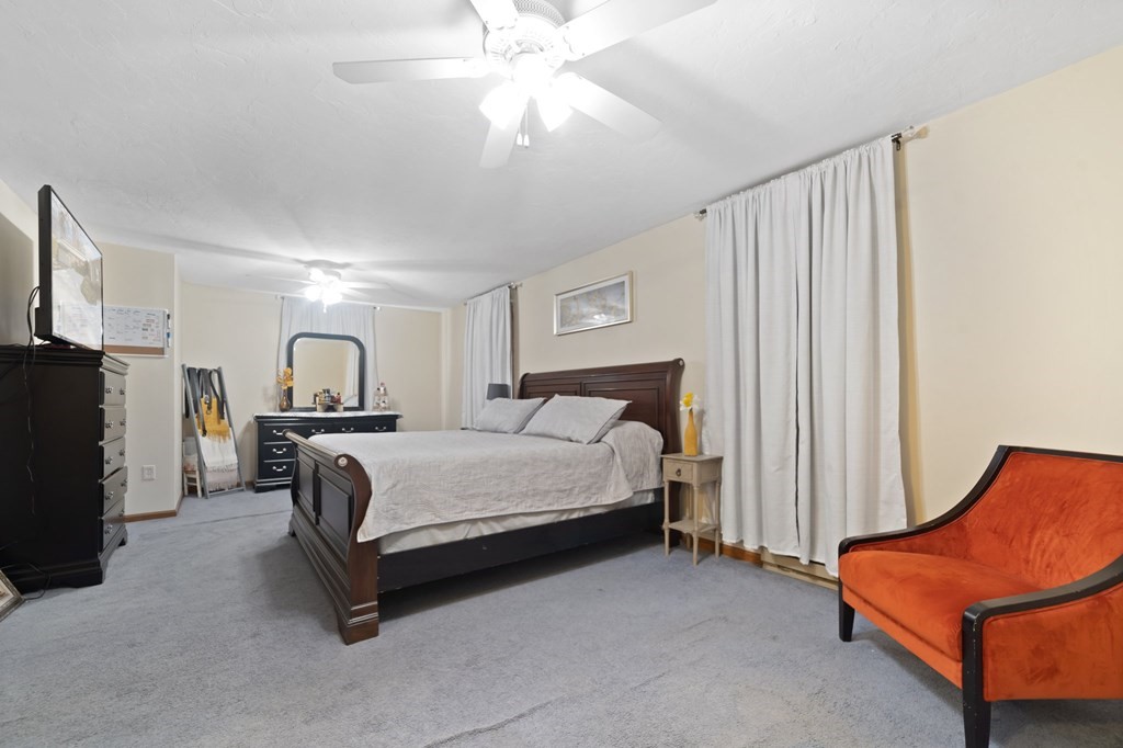 100 Barry Road Worcester, MA 01609 - Photo 21 of 37 a spacious bedroom with a bed and a couch