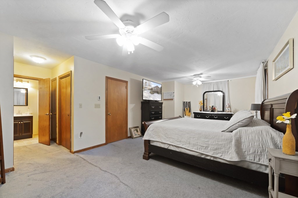 100 Barry Road Worcester, MA 01609 - Photo 22 of 37 a bedroom with a large bed a flat tv screen and dresser