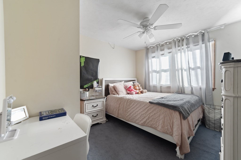 100 Barry Road Worcester, MA 01609 - Photo 28 of 37 a bedroom with a bed and a chandelier