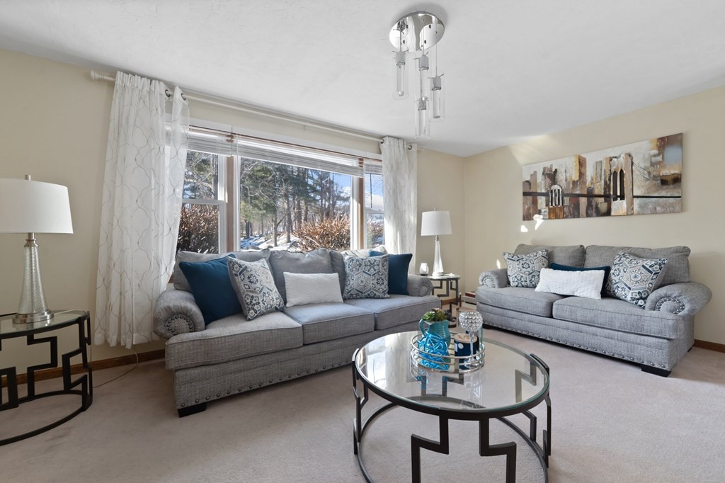 100 Barry Road Worcester, MA 01609 - Photo 4 of 37 a living room with furniture a table and a chandelier