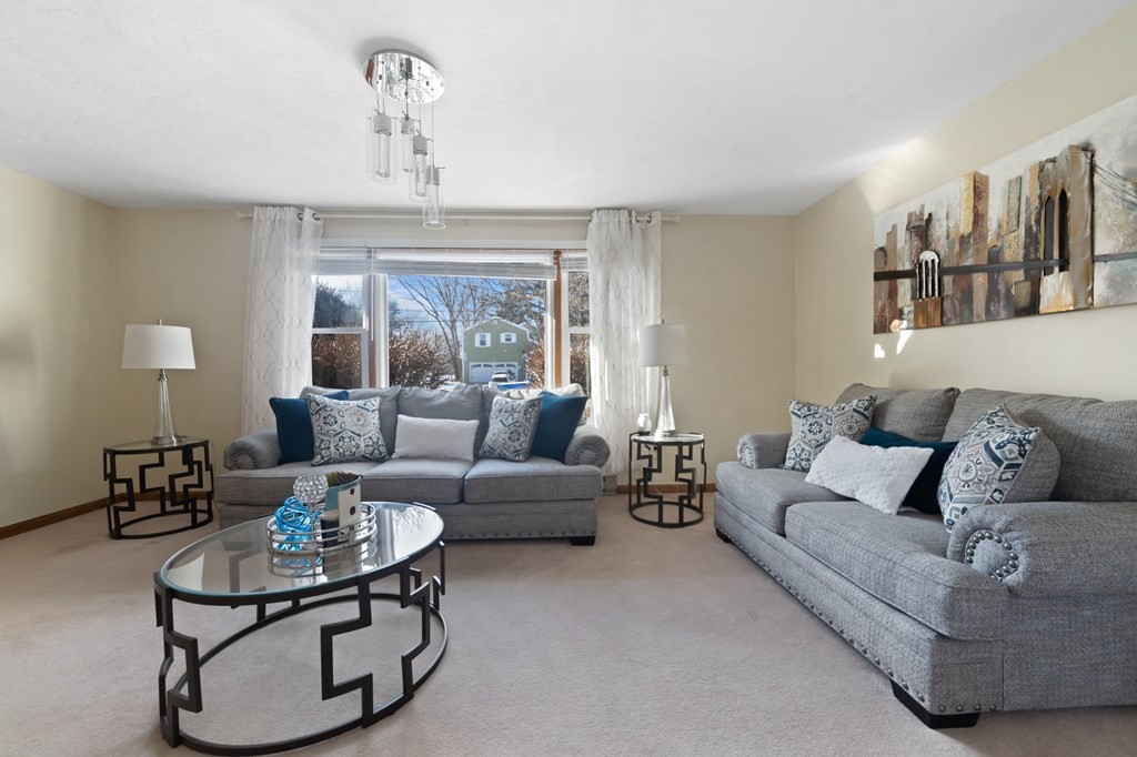 100 Barry Road Worcester, MA 01609 - Photo 5 of 37 a living room with furniture and a chandelier