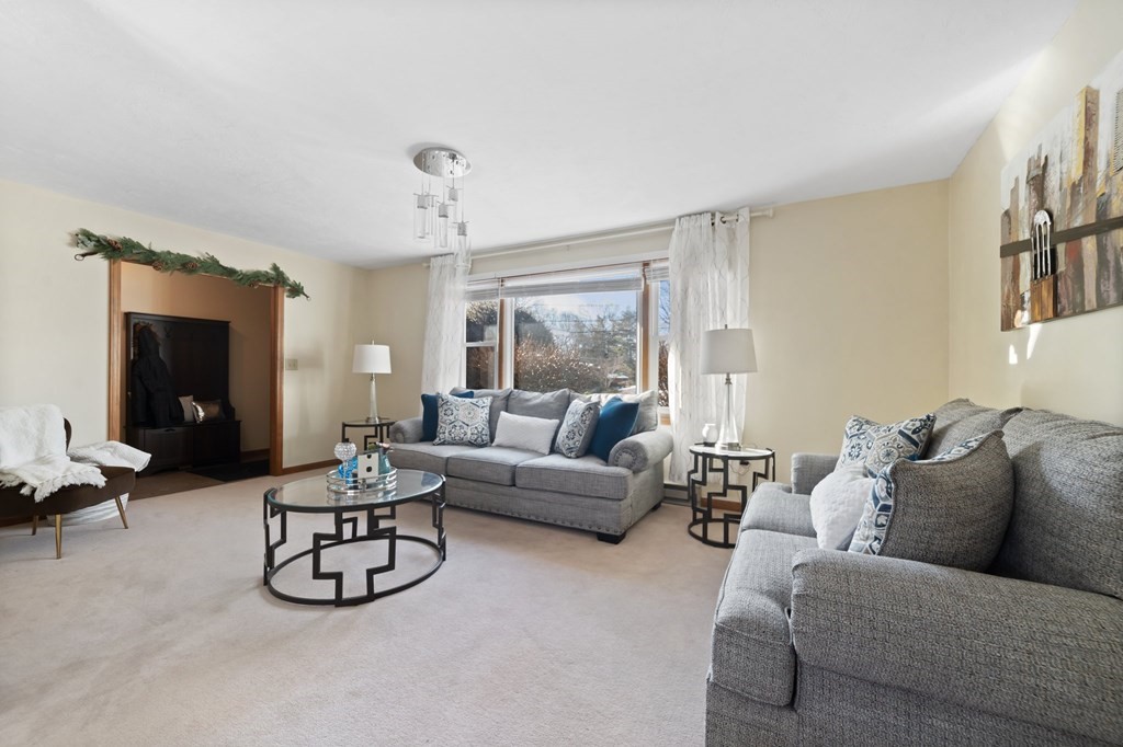 100 Barry Road Worcester, MA 01609 - Photo 6 of 37 a living room with furniture a couch and a chandelier