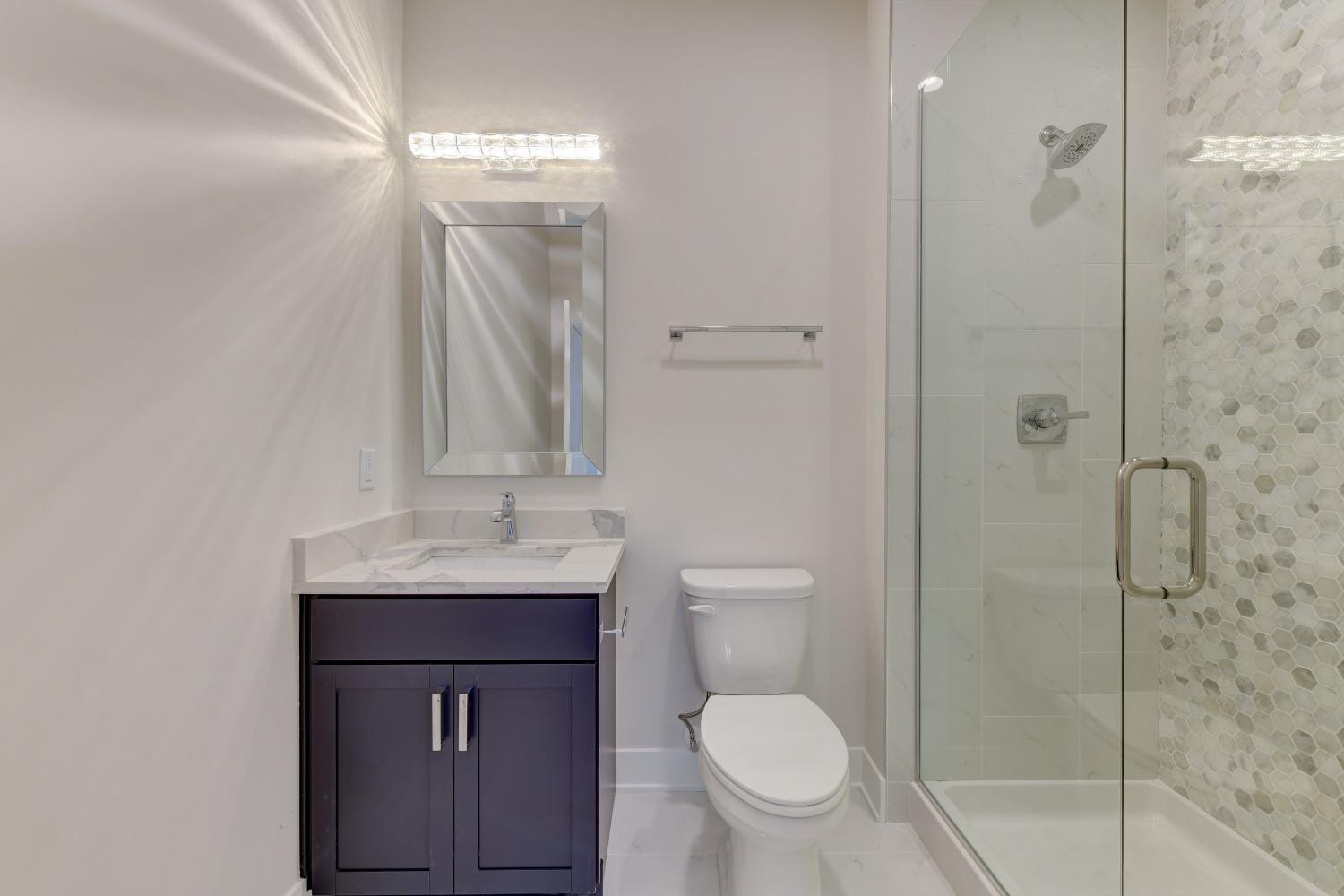 8147 Castle Drive Munster, IN 46321 - Photo 13 of 37 a bathroom with a granite countertop sink toilet and shower