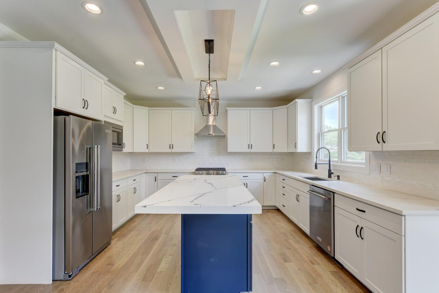 8147 Castle Drive Munster, IN 46321 - Photo 6 of 37 a kitchen with a sink a refrigerator a stove and cabinets