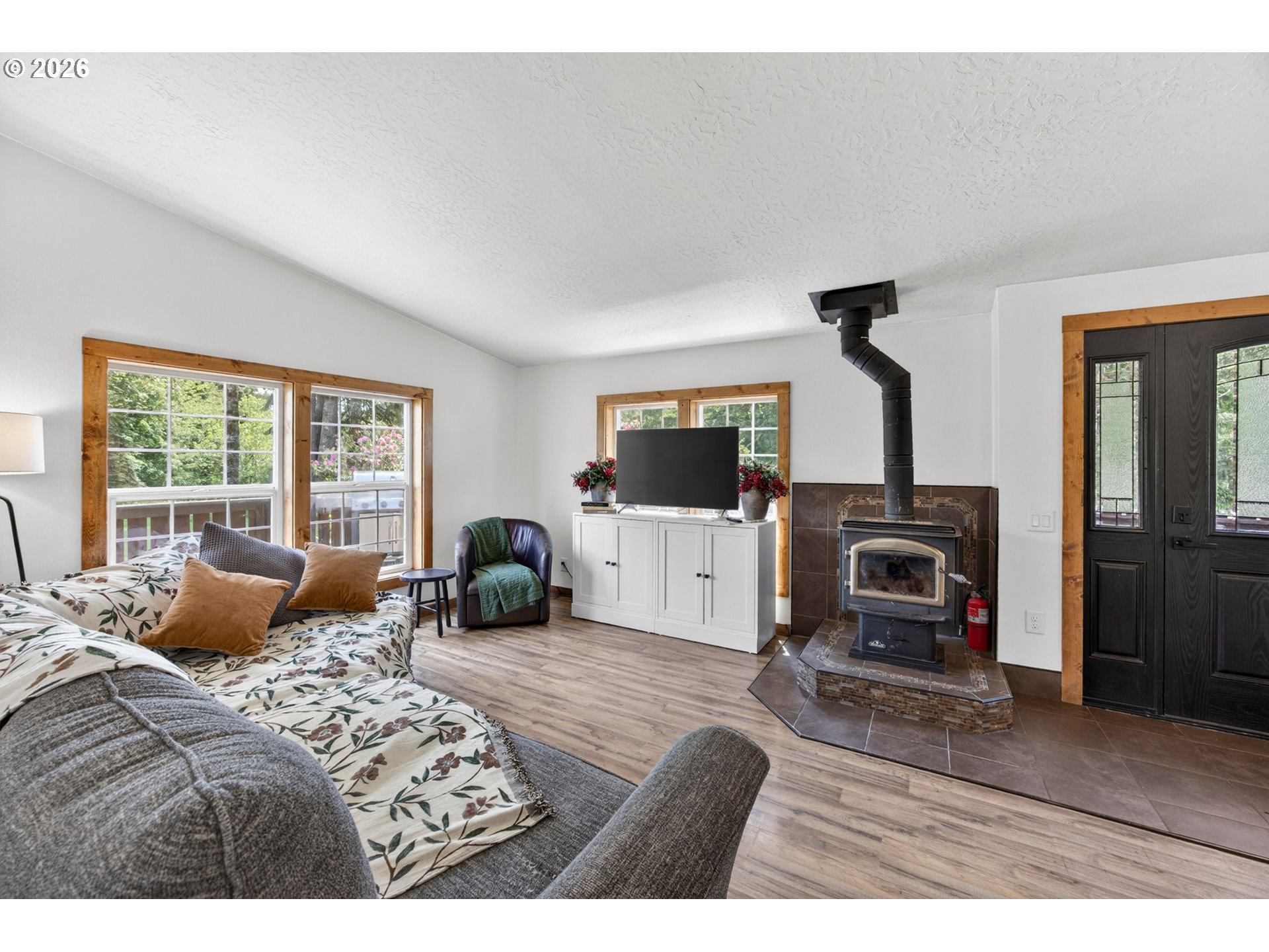 6895 Canary Road Westlake, OR 97493 - Photo 13 of 40 a bedroom with furniture a window and a fireplace