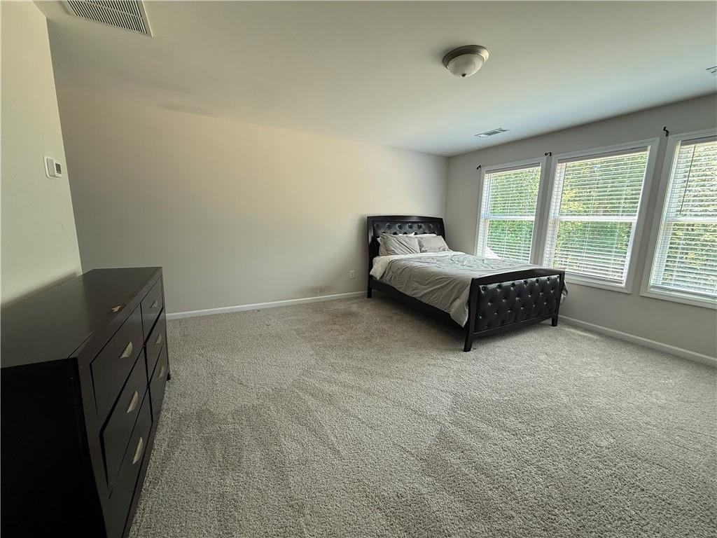 358 Mulberry Road Winder, GA 30680 - Photo 8 of 21 a spacious bedroom with a bed and a window
