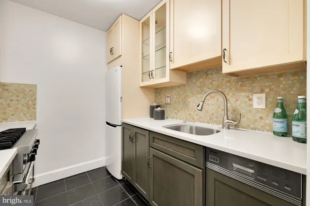a kitchen with a sink and cabinets