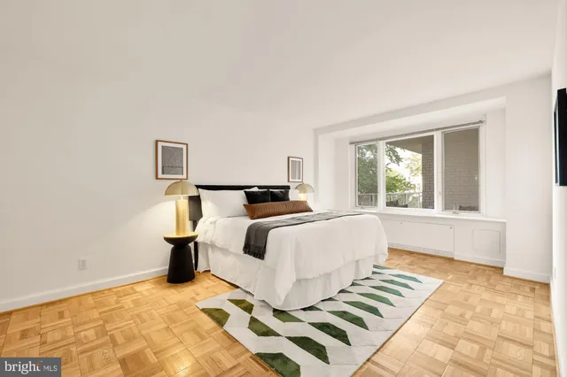 a bedroom with a bed and a night stand