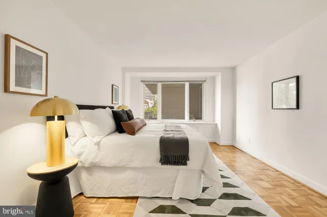 a bedroom with a bed and a lamp