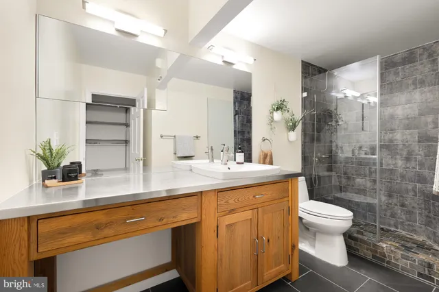 a bathroom with a sink toilet and shower