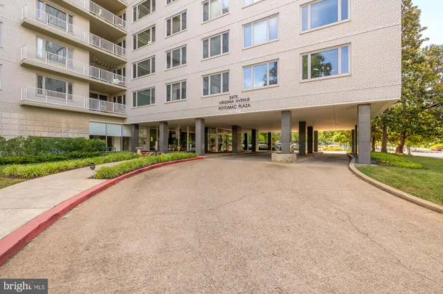 a living room with furniture a lamp and a table with wooden floor
