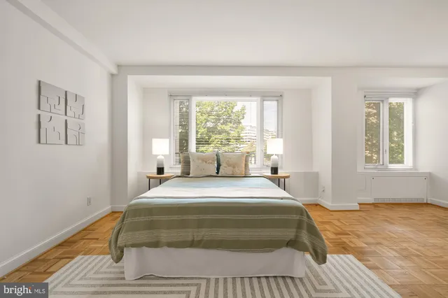 a spacious bedroom with a bed and a table in it