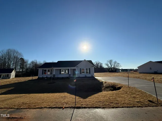 a view of a lake with a house in the background