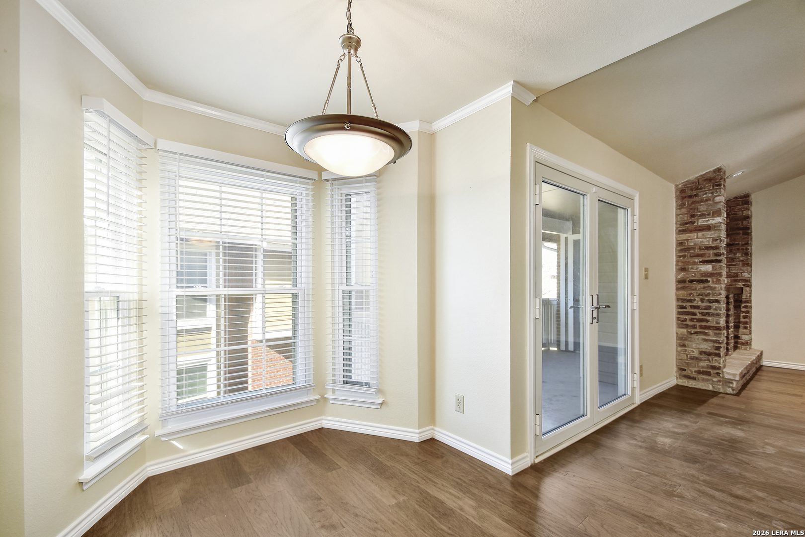 13130 Blanco Road, Unit 1706 San Antonio, TX 78216 - Photo 6 of 23 a view of an empty room with a window and wooden floor