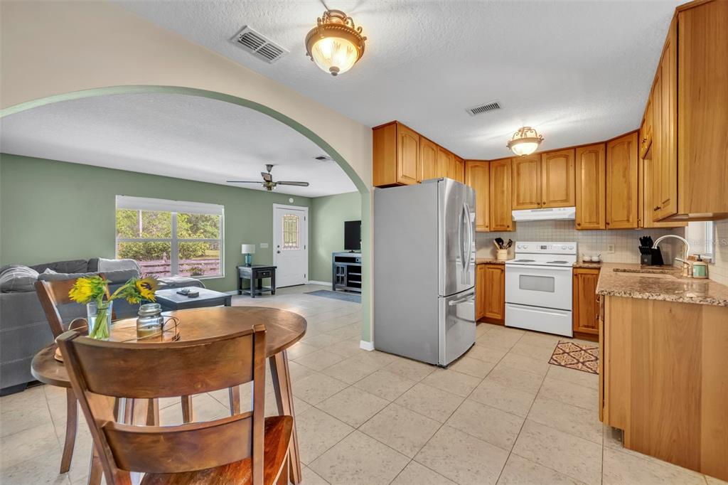 430 Cypress Isles Road Osteen, FL 32764 - Photo 11 of 55 a kitchen with refrigerator a table and chairs