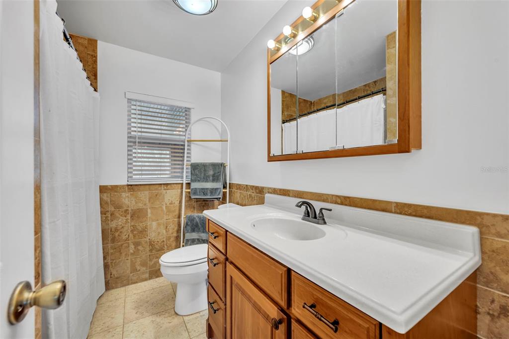 430 Cypress Isles Road Osteen, FL 32764 - Photo 21 of 55 a bathroom with a sink a toilet and a mirror